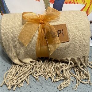 Cream Throw Blanket with NBC Peacock logo